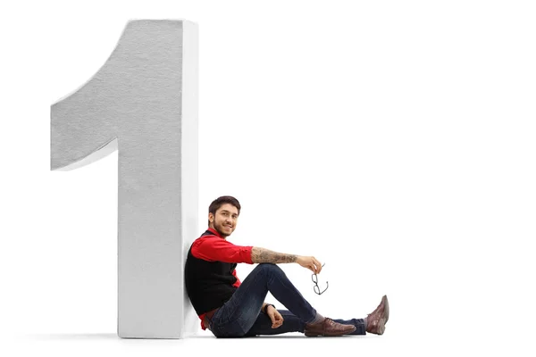 Ragazzo appoggiato ad un numero uno — Foto Stock