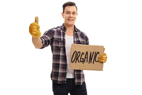 Farmer holding a cardboard sign and making a thumb up sign — Stock Photo, Image