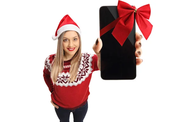 Woman wearing a christmas hat showing a phone as a gift — Stock Photo, Image