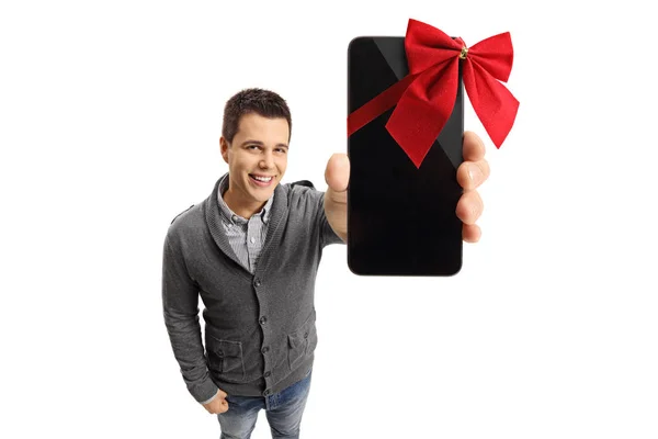 Adam bir hediye olarak bir kurdele ile sarılmış bir telefon gösterilen — Stok fotoğraf