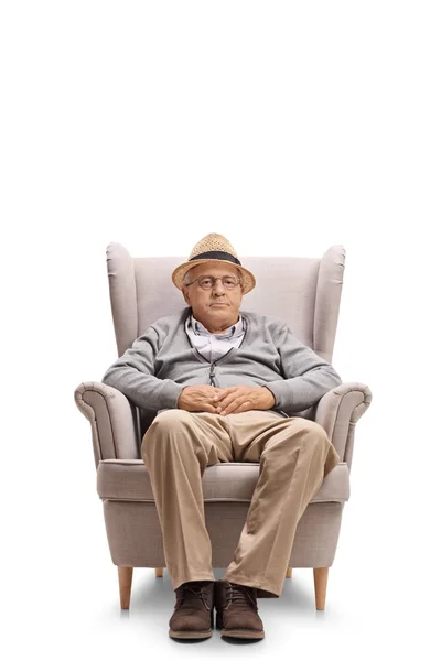 Mature man seated in an armchair — Stock Photo, Image