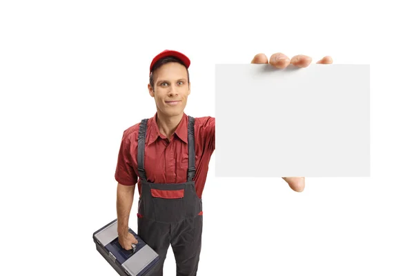 Serviceman with a toolbox showing a blank card — Stock Photo, Image