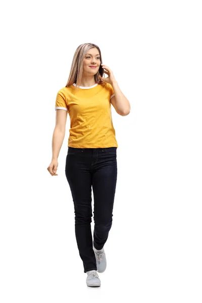 Woman walking and taking on a phone — Stock Photo, Image