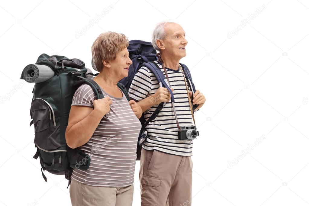 Two elderly hikers looking away