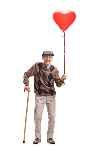 Sénior com um balão em forma de coração e uma bengala — Fotografia de Stock