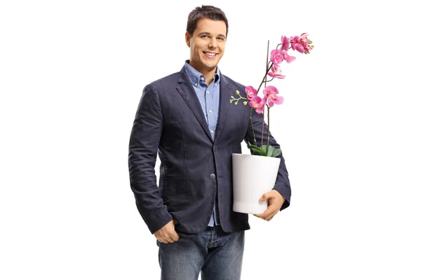 Guy holding an orchid flower in a pot — Stock Photo, Image