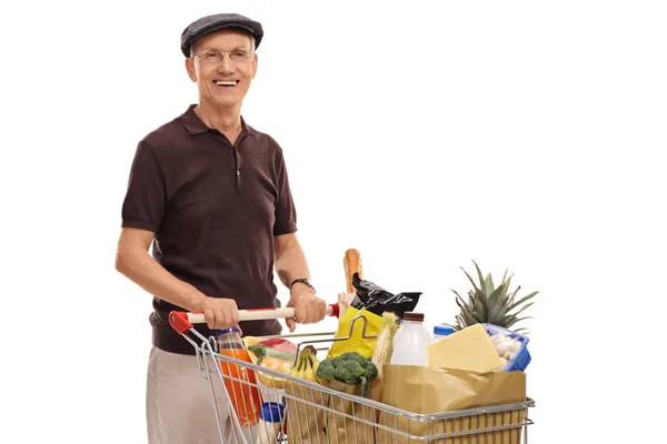 Senior with a shopping cart full of groceries — Stock Photo, Image
