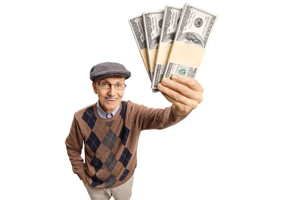 Elderly man showing bundles of money — Stock Photo, Image