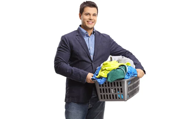 Man with a laundry basket full of clothes — Stock Photo, Image