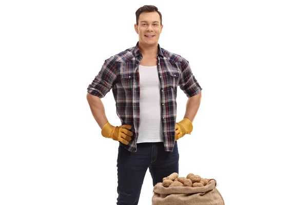 Farmer with a burlap sack filled with potatoes — Stock Photo, Image