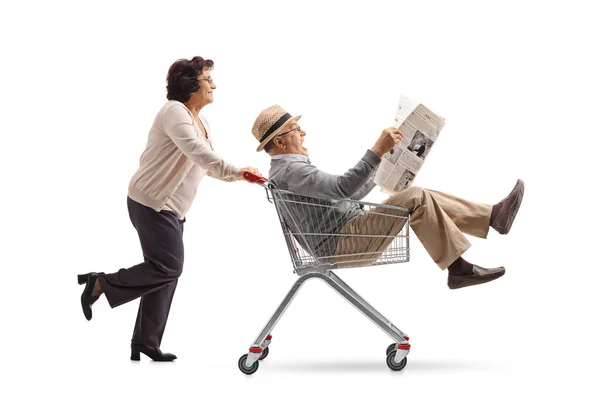 Mujer empujando un carrito de compras con un hombre — Foto de Stock