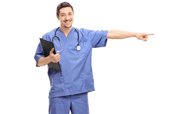 Doctor holding a clipboard and pointing — Stock Photo, Image