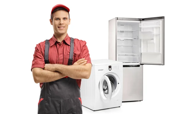 Repairman in front of a washing machine and a refrigerator — Stock Photo, Image