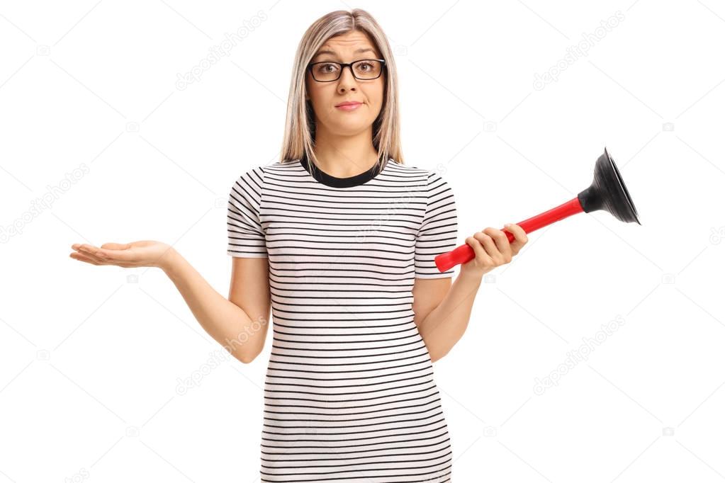 Confused young woman with a plunger