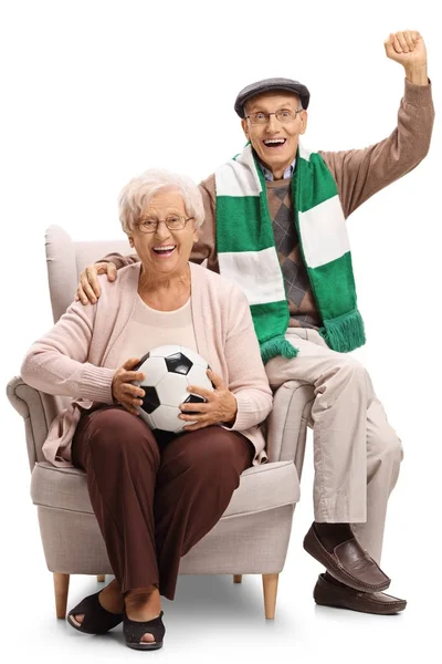 Cheerful soccer fans sitting in an armchair — Stock Photo, Image