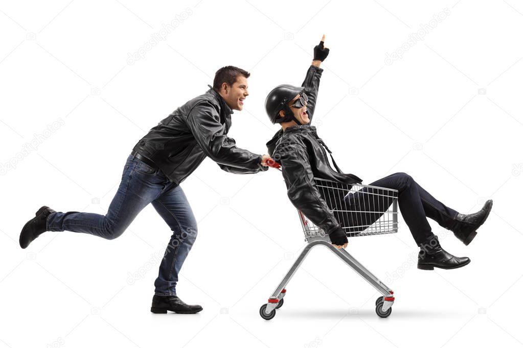 Biker pushing a shopping cart with another biker 