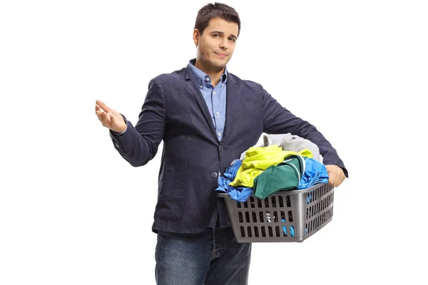 Guy holding a laundry basket filled with clothes — Stock Photo, Image