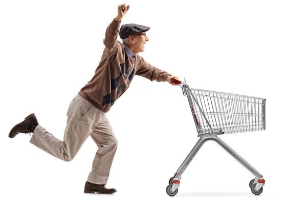 Senior pushing an shopping cart and holding his hand up — Stock Photo, Image