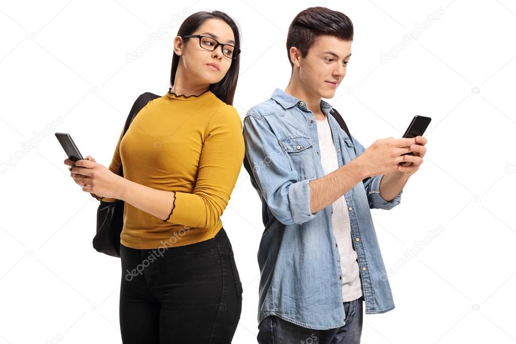 Female student peeking at the phone of a male student