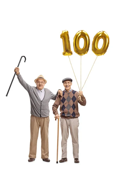 Cheerful seniors with a number hundred balloons — Stock Photo, Image