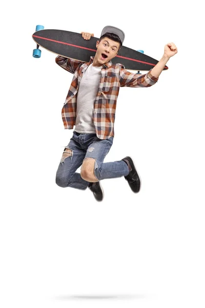 Hipster with a longboard jumping and gesturing happiness — Stock Photo, Image