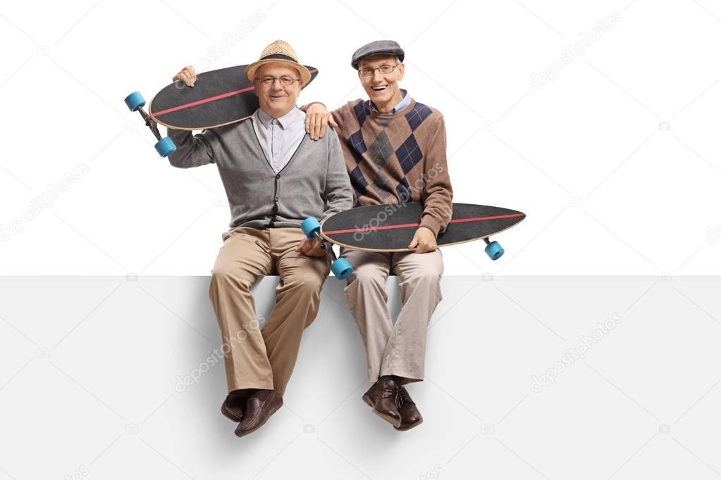 Seniors with longboards sitting on a panel