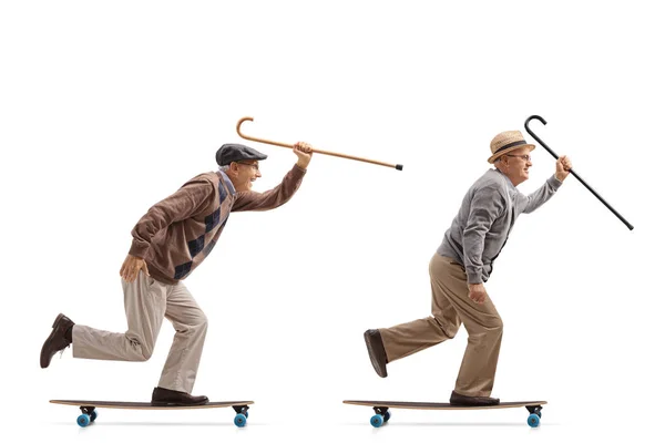 Homens idosos com canas montando longboards — Fotografia de Stock