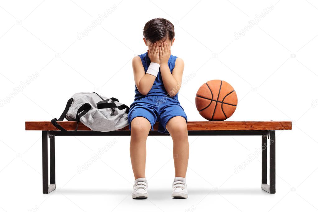 Sad basketball player sitting on a bench