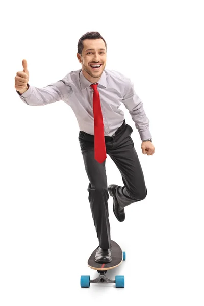 Businessman riding a longboard and making a thumb up gesture — Stock Photo, Image