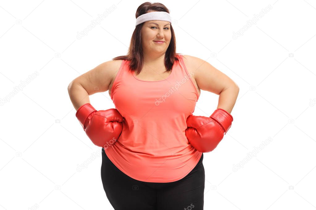 Overweight woman posing with boxing gloves