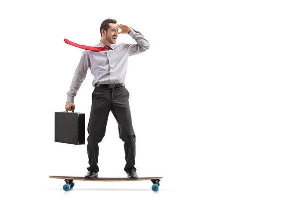 Businessman with a briefcase riding a longboard — Stock Photo, Image