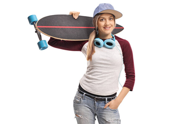 Female skater with a longboard and a pair of headphones