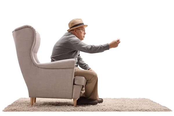 Angry senior sitting in an armchair and arguing — Stock Photo, Image