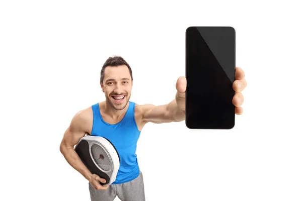 Людина тримає вагу і телефон — стокове фото