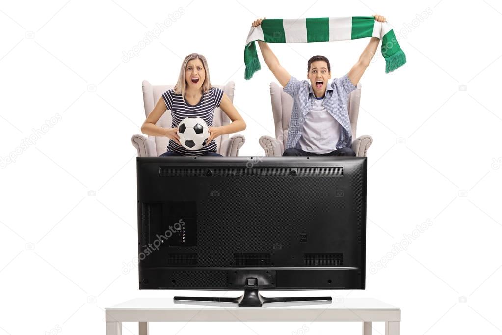 woman and man watching football on television 