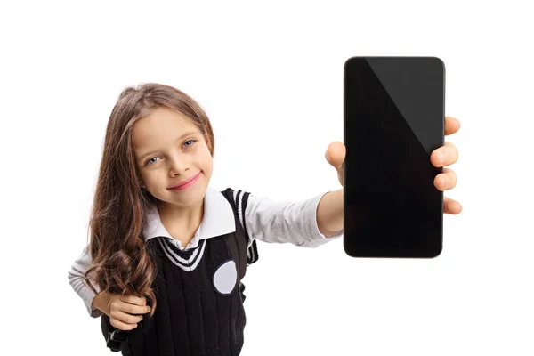 Little schoolgirl showing a phone and smiling — Stock Photo, Image