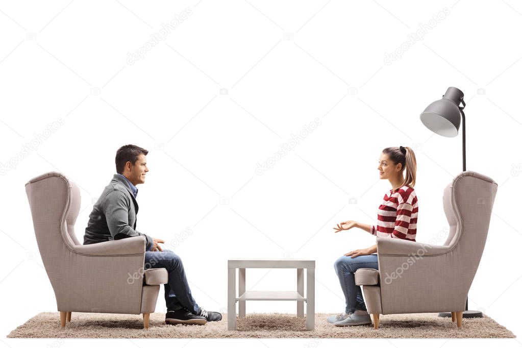 couple seated in armchairs having a conversation