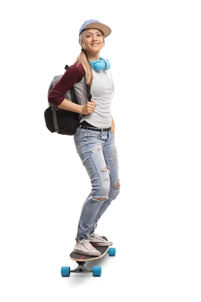 Female skater with a backpack riding a longboard — Stock Photo, Image