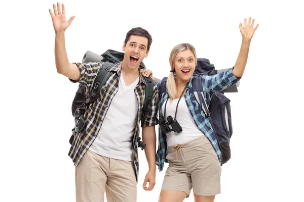 Cheerful young hikers waving at the camera — Stock Photo, Image