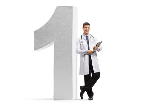 Doctor leaning against a number one figure — Stock Photo, Image