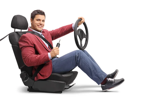 Guy seated in a car seat with car key — Stock Photo, Image