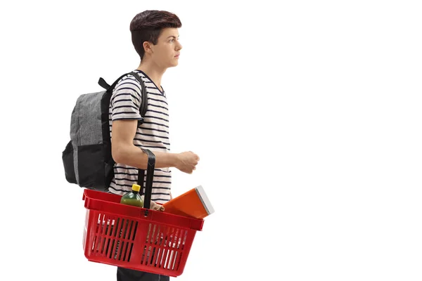 Adolescente com uma mochila e uma cesta de compras — Fotografia de Stock