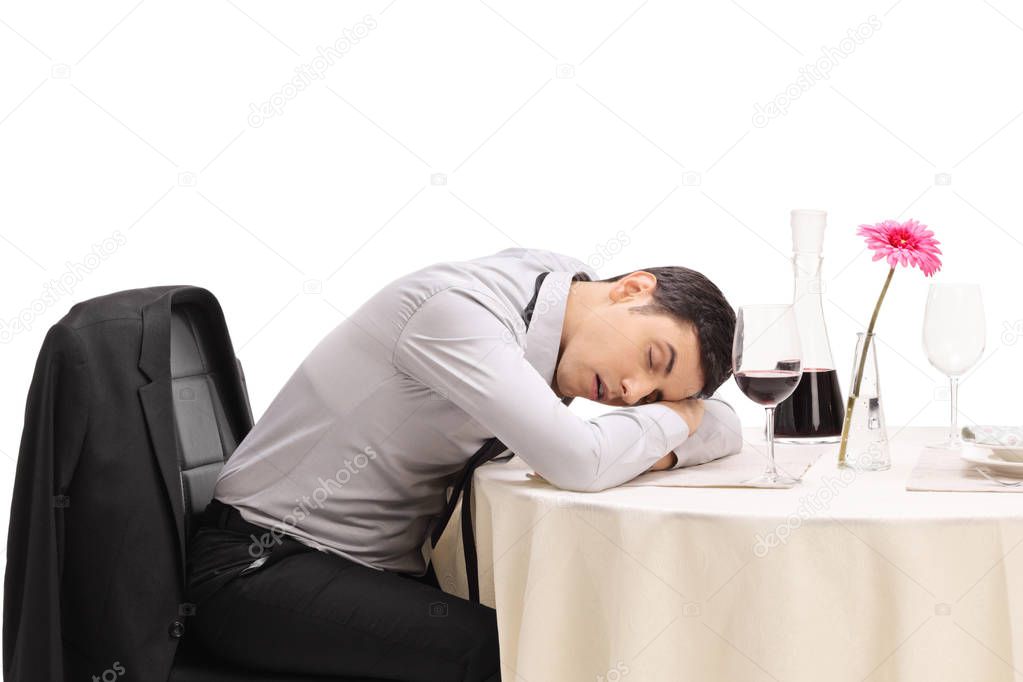 Drunk man sleeping on a restaurant table