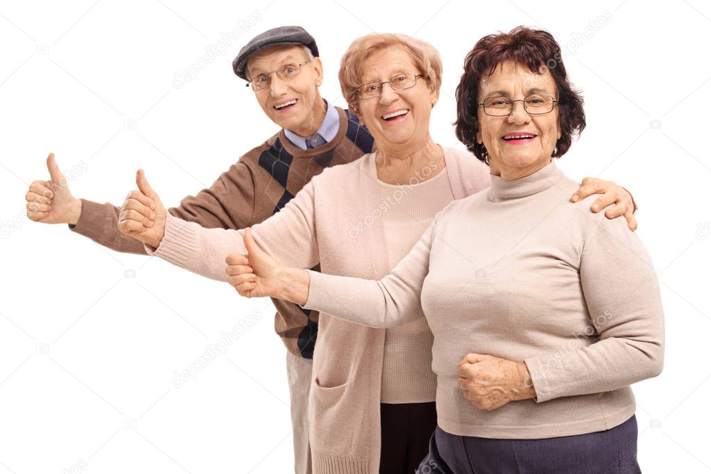 Joyful seniors making thumbs up gestures