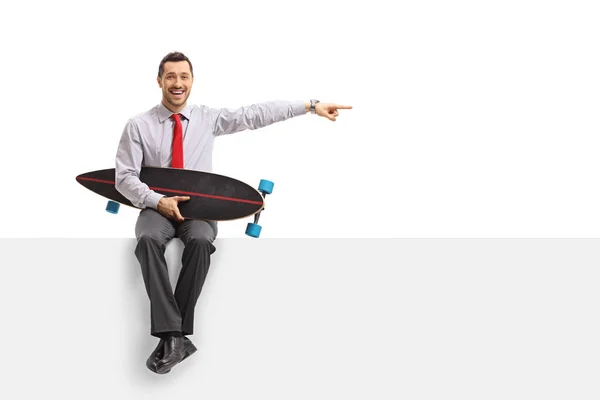 Businessman Longboard Sitting Panel Pointing Isolated White Background — Stock Photo, Image