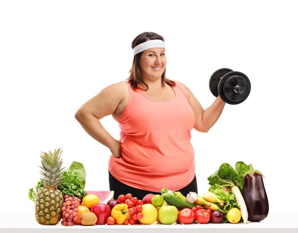 Overweight Woman Holding Dumbbell Table Full Fruit Vegetables Isolated White — Stock Photo, Image