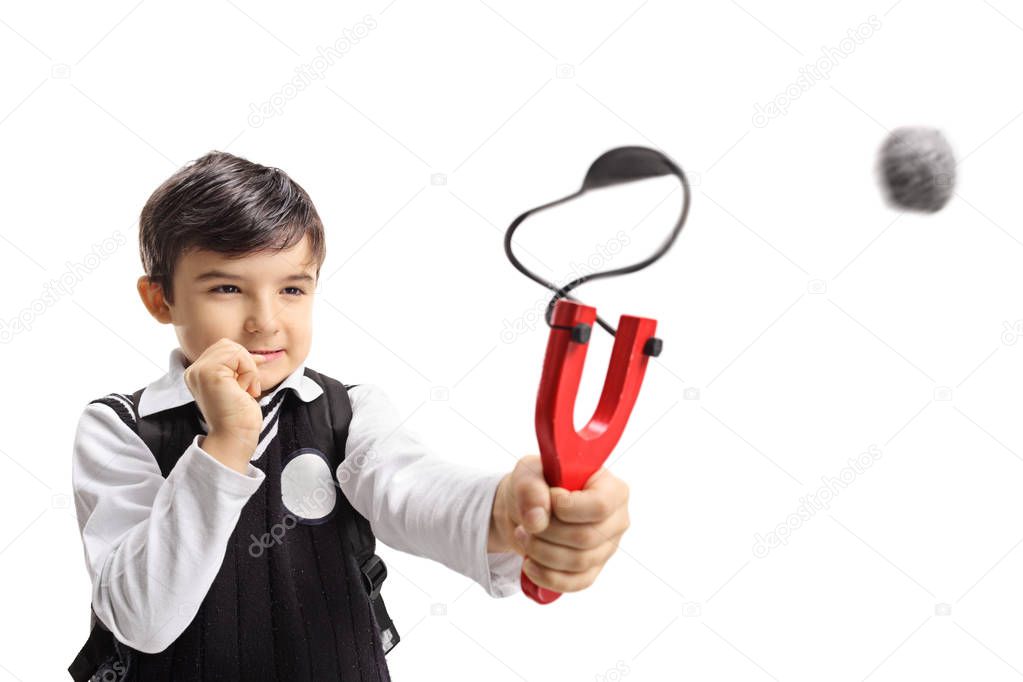 Schoolboy shooting a slingshot isolated on white background
