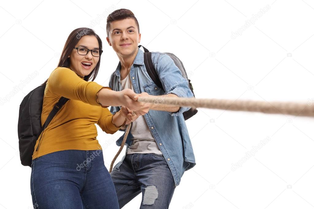 Teenage students pulling a rope together