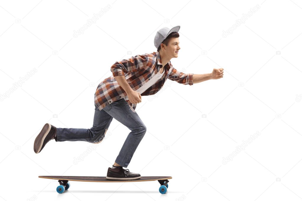 Full length profile shot of a teen hipster riding a longboard isolated on white background