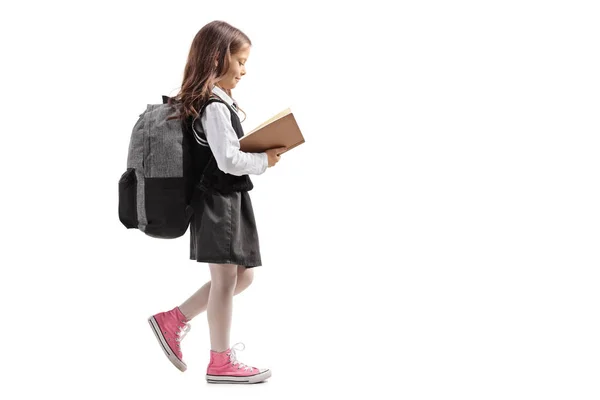 Full Length Profile Shot Little Schoolgirl Walking Reading Book Isolated — Stock Photo, Image